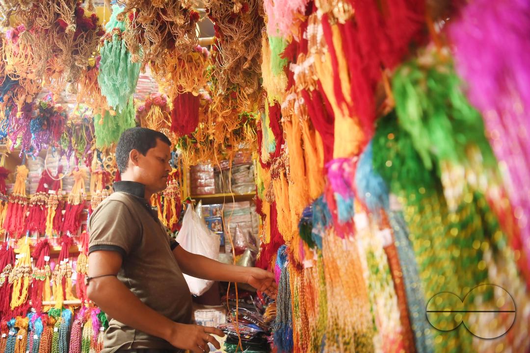 A shop owner arranging "Rakhi", sacred threads for the upcoming "Raksha Bandhan" festival at his shop in Agartala