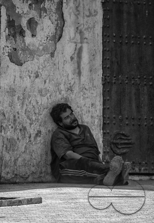 A man seated on the streets of Tangier, a Moroccan port on the Strait of Gibraltar, has been a strategic gateway between Africa and Europe since Phoenician times