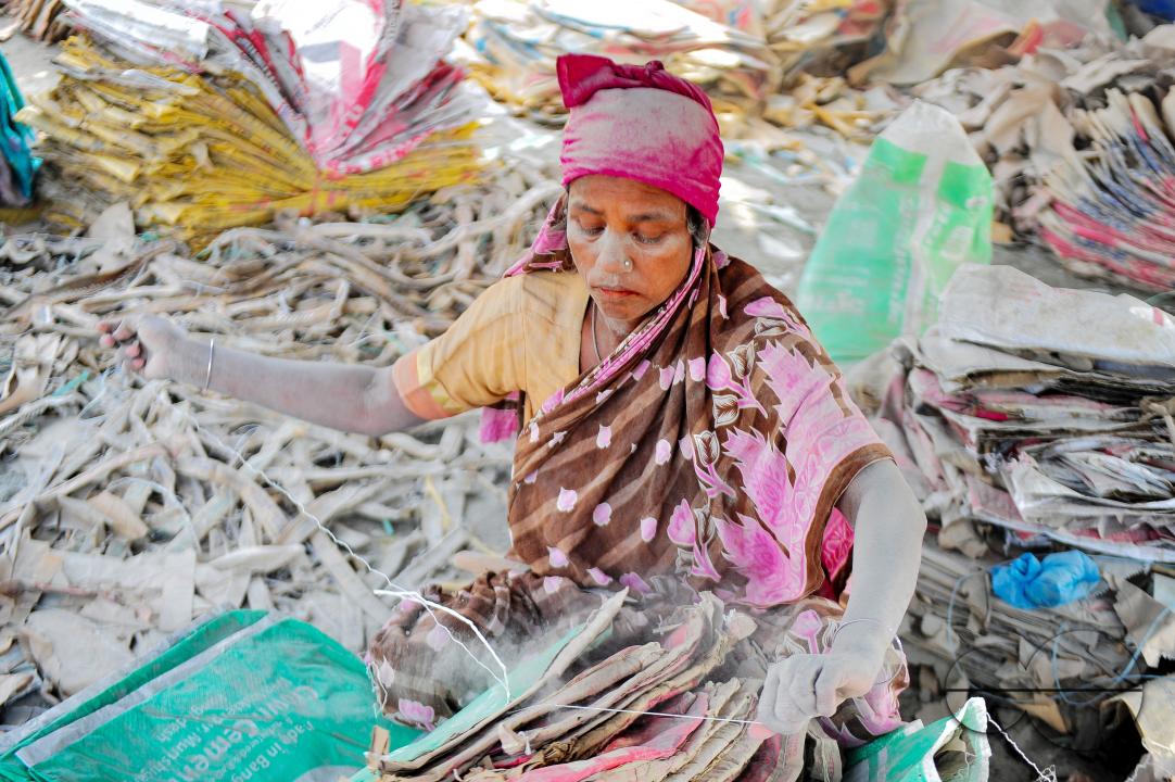 Women are risking their lives to wash cement bags beside the Surma River in Sylhet