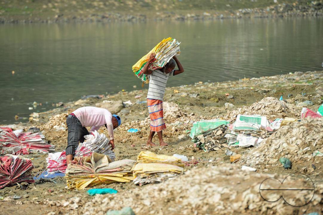Women are risking their lives to wash cement bags beside the Surma River in Sylhet