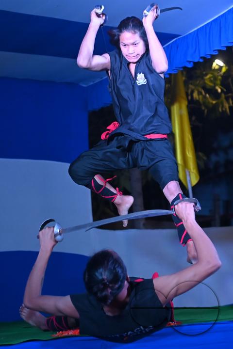 Manipuri martial arts students performing at the opening program of the 225th Raas Festival in Radha madhab Mandir at Agartala