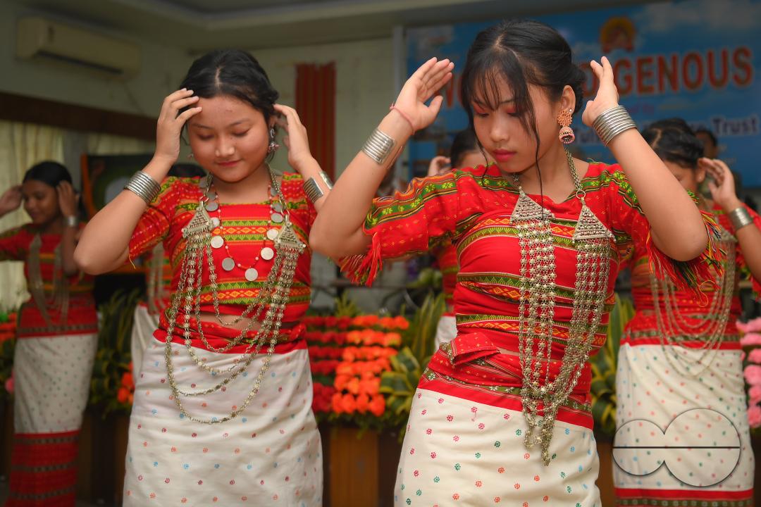 Indigenous girls perform traditional dances on the occasion of World Indigenous Day in an auditorium at Agartala