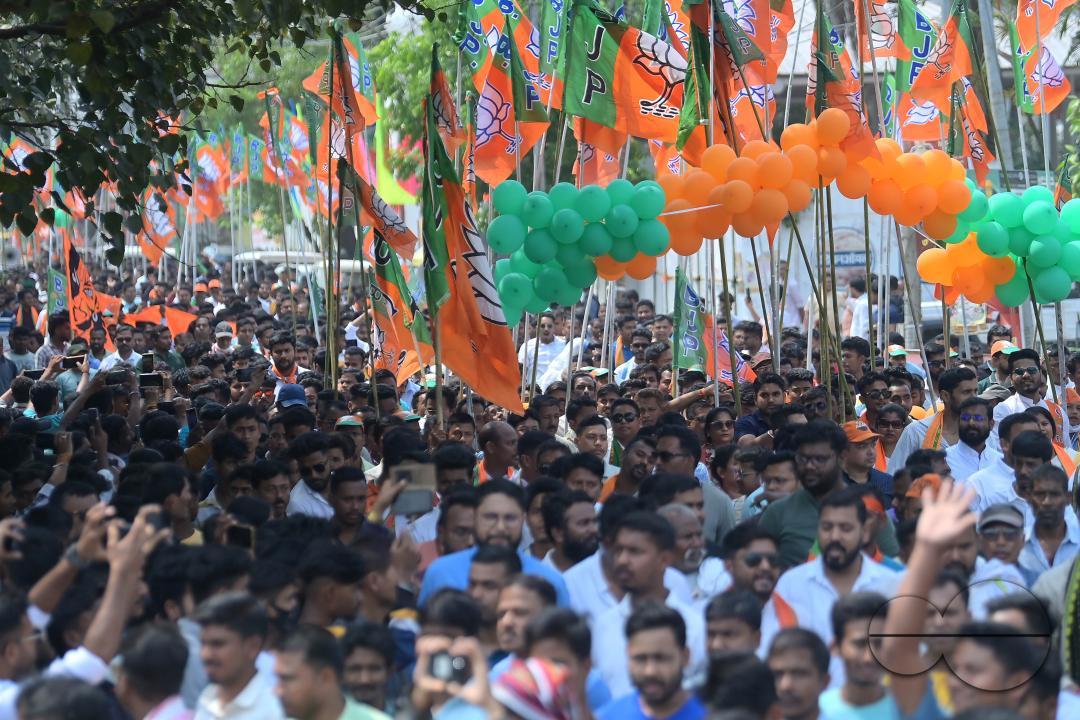 BJP supporters seen in a rally with Tripura Chief Minister Manik Saha, former CM and BJP candidate Biplab Kumar Deb, and Kriti Singh along with other leaders during an election campaign rally in support of Lok Sabha candidates at Agartala