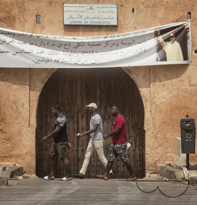 Tourists exploring the historic site of Hassan Tower
