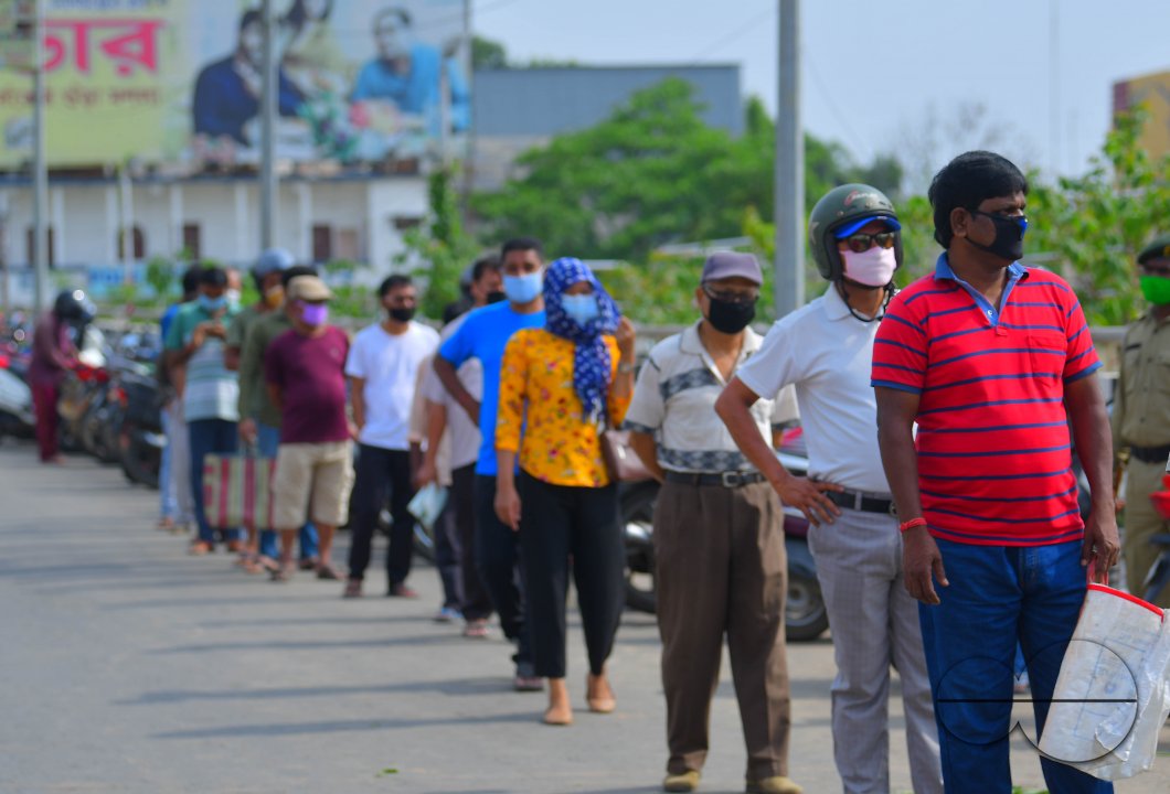 People are standing in a line, to check their temperatures
