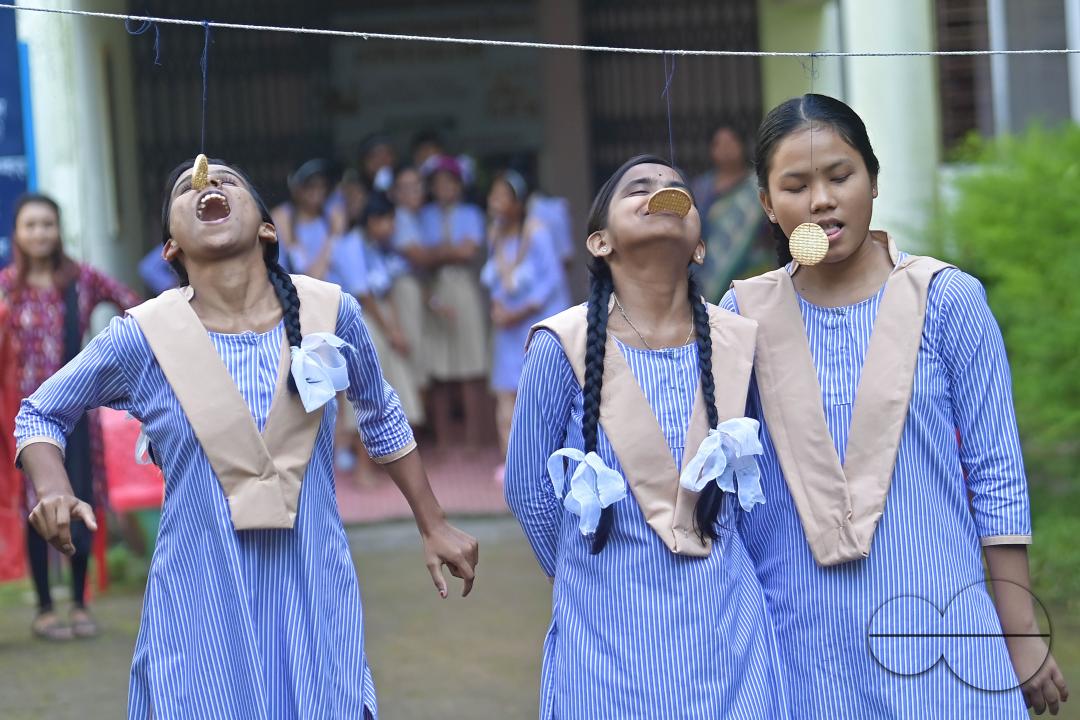 Students at the Institute for Visually Handicapped are participating in a 'Biscuit Race' during the 'Children's Day' celebration at the institute's campus in Narsingarh, in Agartala