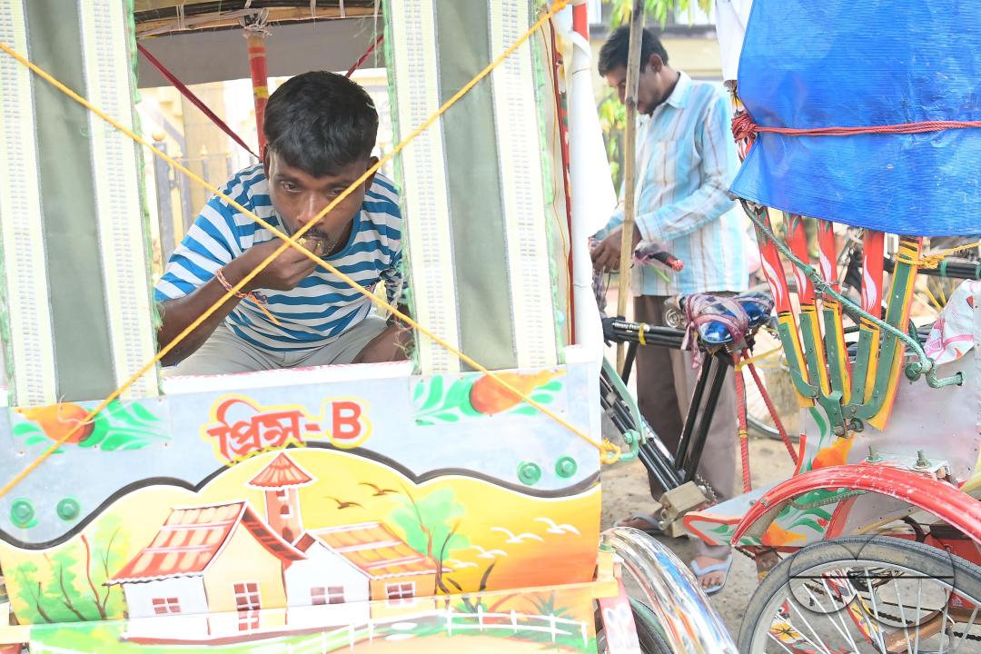 A rickshaw puller eats food distributed by a social worker on World Food Safety Day organised by Rotary Club of Agartala, in Agartala
