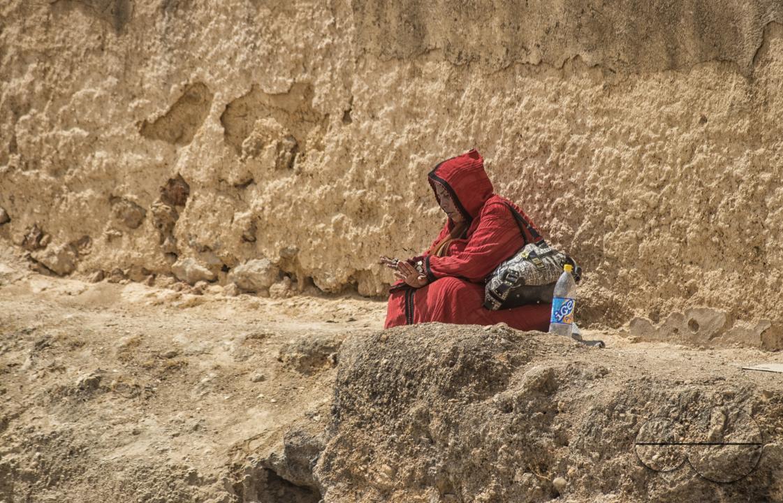 A woman seated in the outskirts of Tangier, a Moroccan port on the Strait of Gibraltar, has been a strategic gateway between Africa and Europe since Phoenician times