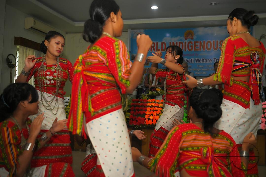 Indigenous girls perform traditional dances on the occasion of World Indigenous Day in an auditorium at Agartala