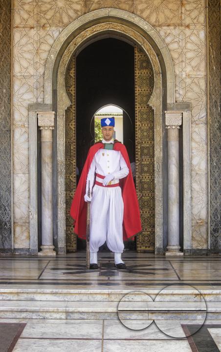Guard in traditional outfit in front of Hassan Tower