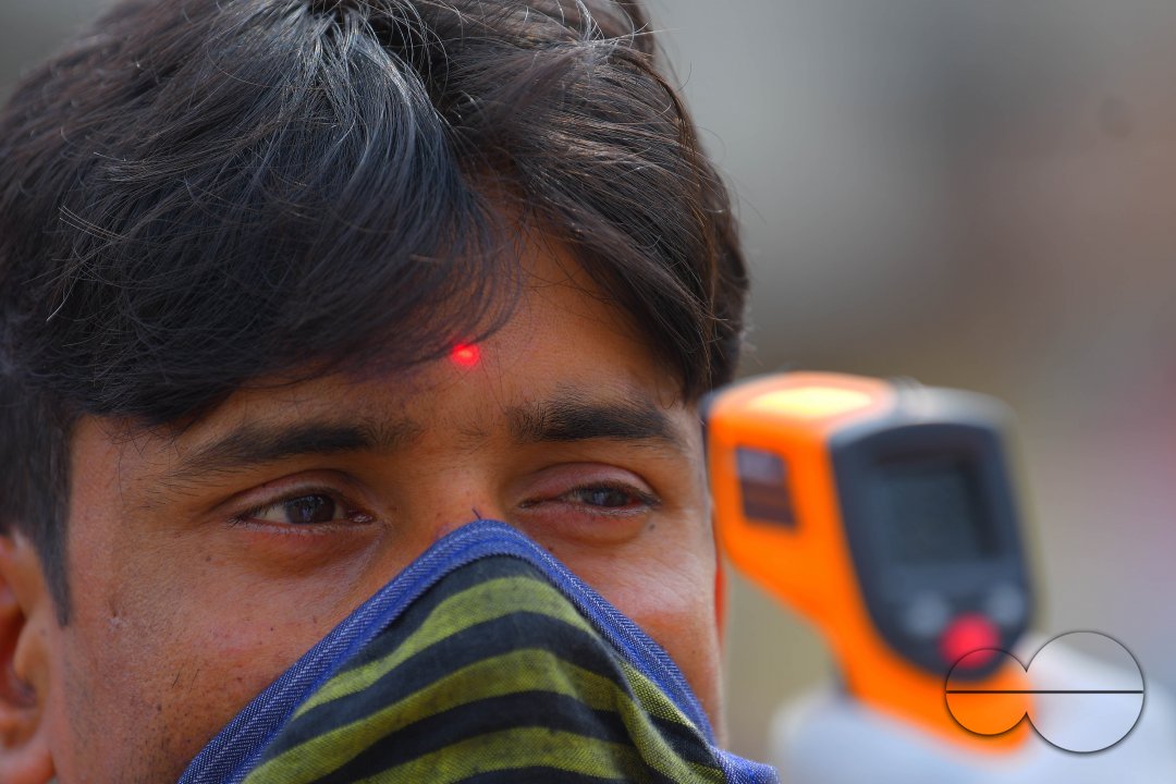 The health workers are applying infrared thermometer to check the temperatures
