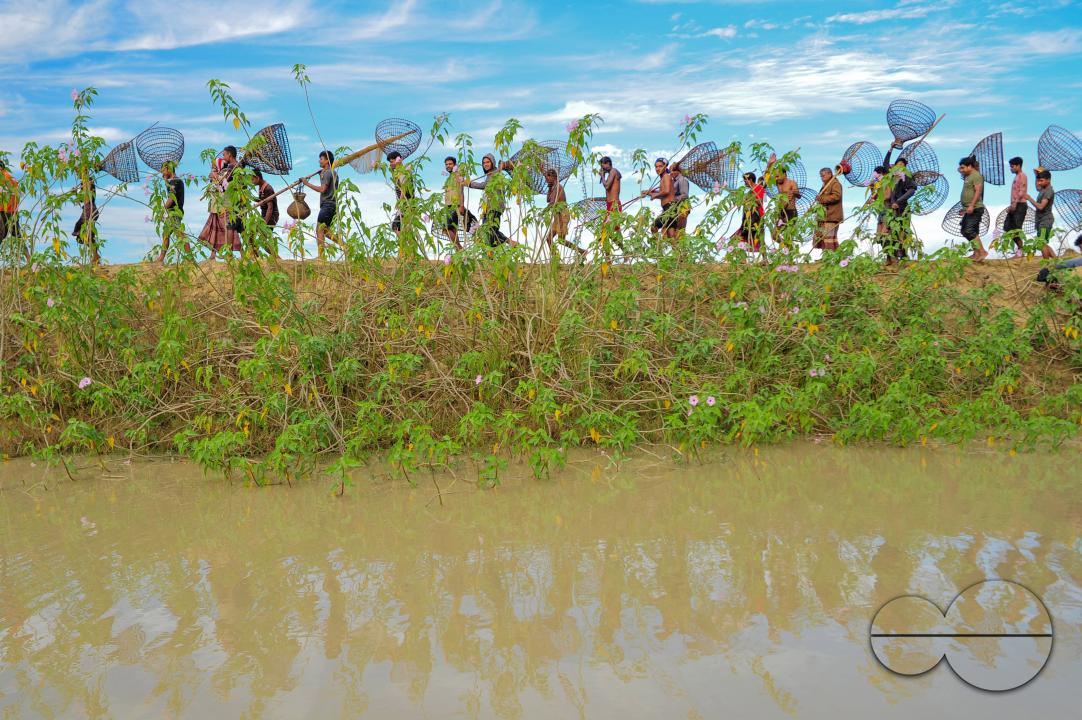Rural people armed with Bamboo fish traps and nets take part in celebrating a 200-year winter fishing festival at the jofra beel of gasbari union of Kanaighat upazila of Sylhet, Bangladesh
