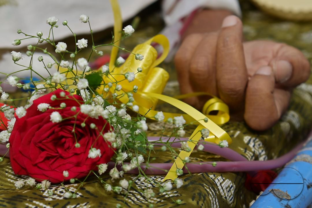 A rose and fruits are distributed to a patient by doctors and health workers during the celebration of World Kindness Day in the dialysis ward at IGM (Indira Gandhi Memorial) Hospital in Agartala