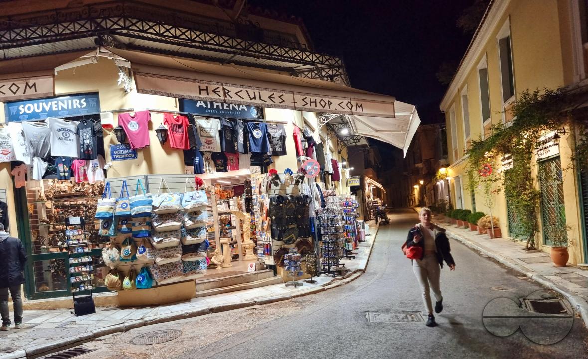 Walking through the center of a market square near a late night shop