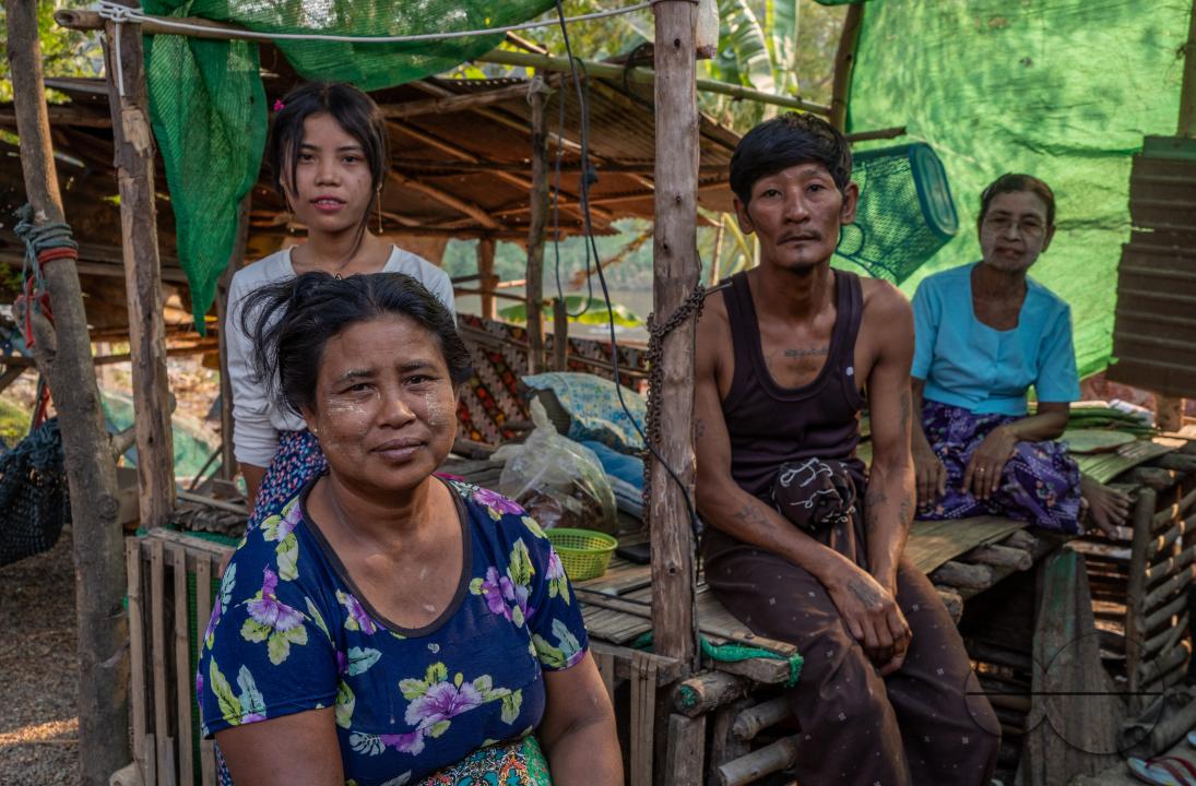 Immigrant Burmese family in their shack in the Thailand - Myanmar Moei river border near Mae Sot, Thailand