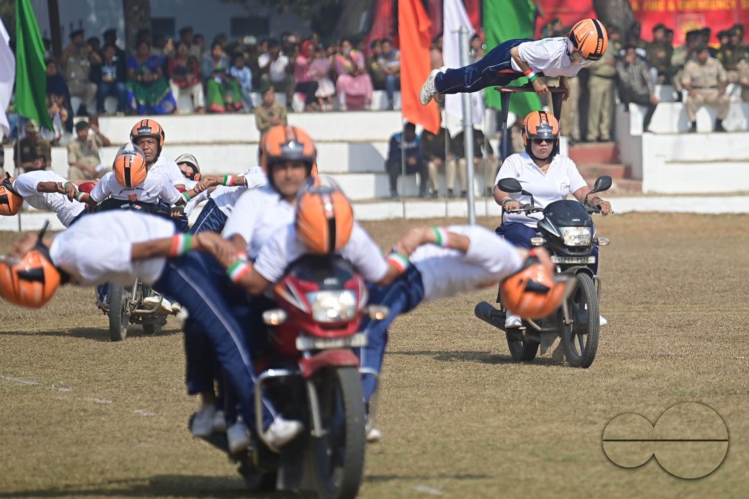 The female police motorcycle display team performs during the celebration of 150 years of Tripura Police Week at the stadium of A.D