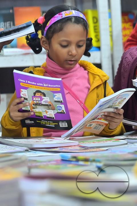 Children looking at books in a book stall at the 42nd Agartala Book fair International Fair Ground, Hapania at Agartala