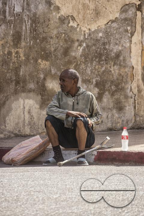 A man seated on the streets of Tangier, a Moroccan port on the Strait of Gibraltar, has been a strategic gateway between Africa and Europe since Phoenician times