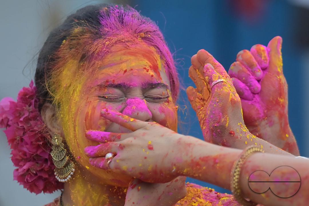 Indian girls adorned with 'Gulal' or coloured powder during the Hindu spring festival 'Holi', the festival of colour in Agartala