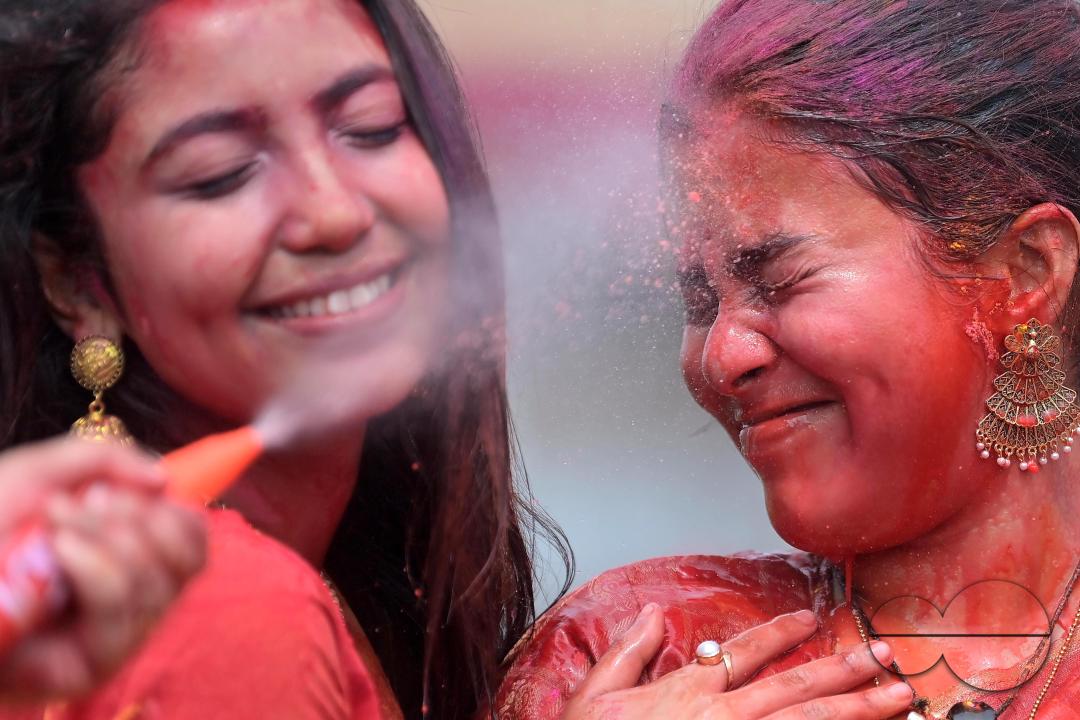 Indian girls adorned with 'Gulal' or coloured powder during the Hindu spring festival 'Holi', the festival of colour in Agartala