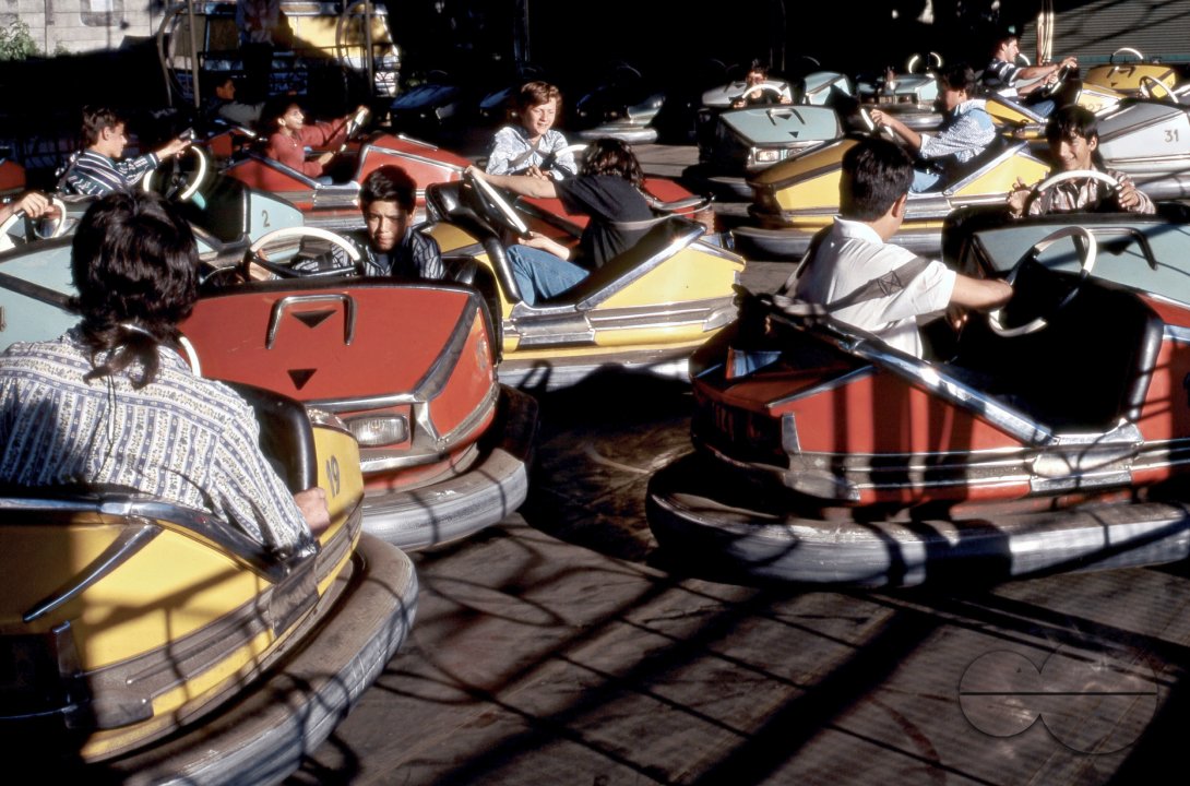 URUGUAY YOUTH PLAYING WITH SCOOTER CARS AT AN AMUSEMENT PARK. Photo  Julio Etchart