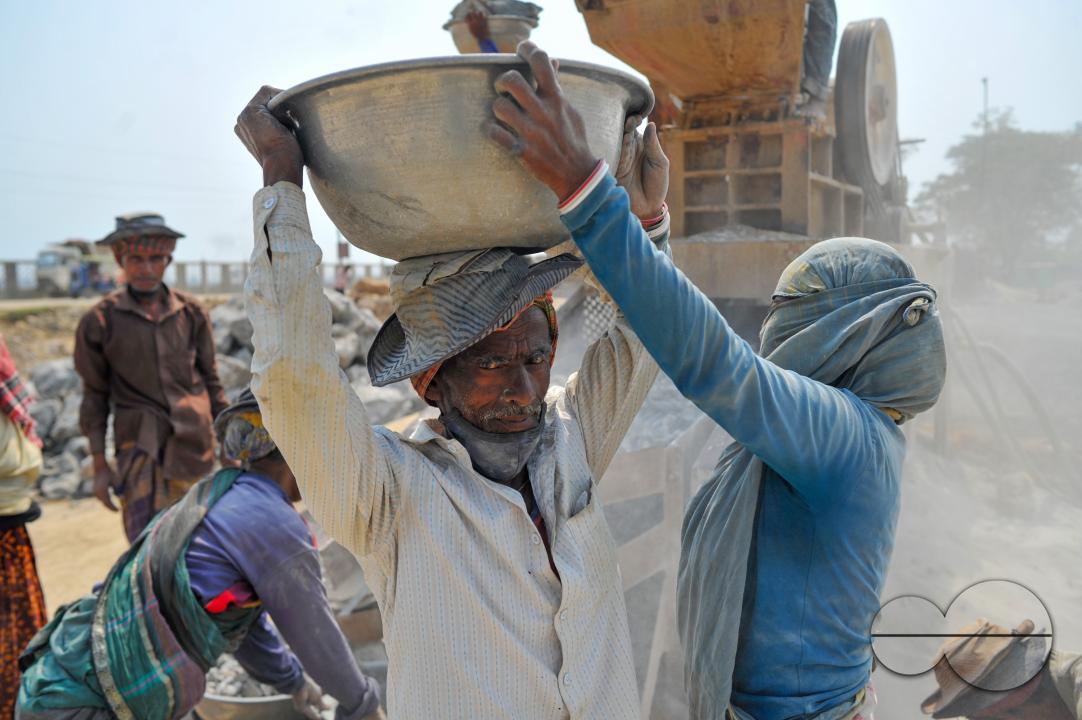 Male and female workers are breaking LC stones with a crusher machine in Bholaganj area, known as the 'Stone State' of Sylhet Companyganj Upazila