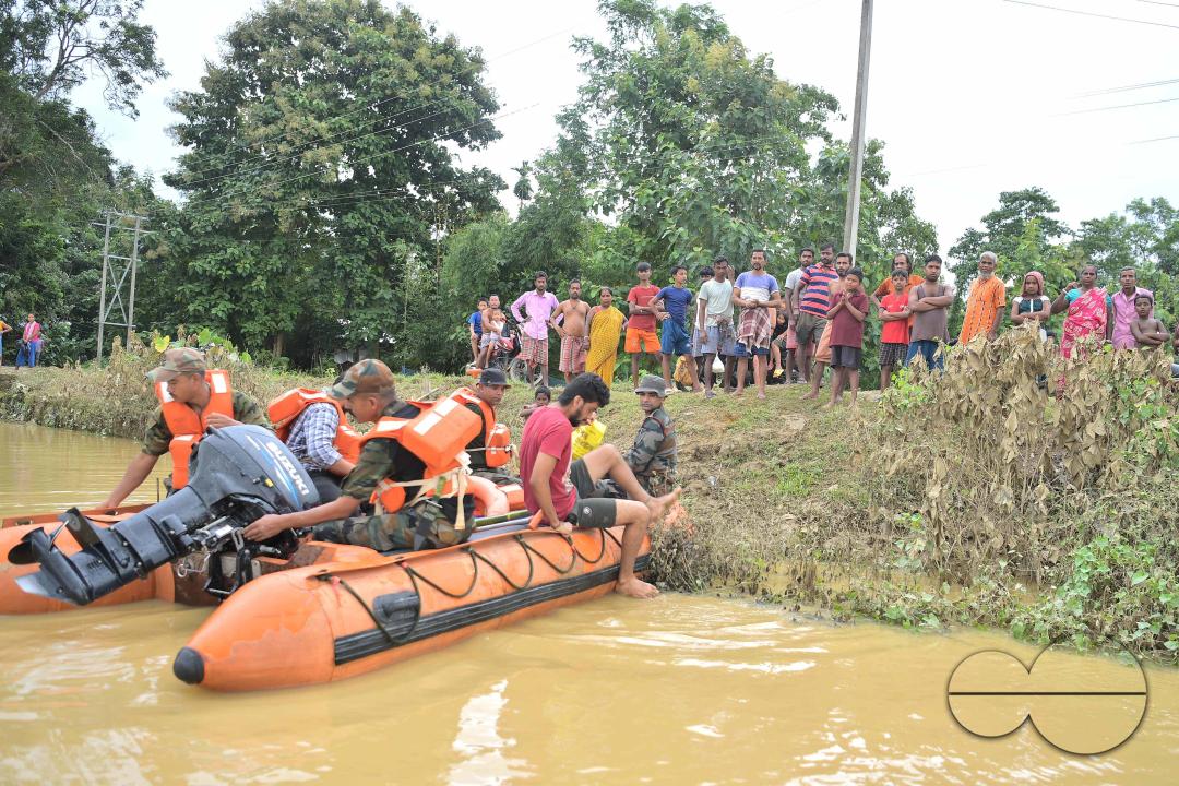 Assam Rifles personnel are carrying a boat to distribute food items to relief camps in different areas of Amarpur city which is immersed by flooded water, 82km away from Agartala