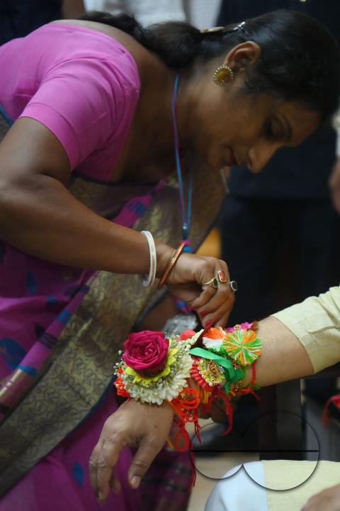 A lady tying rakhi and doing other rituals to Tripura CM Professor Dr