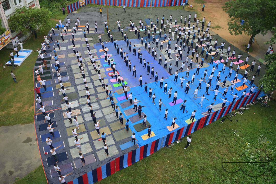 NCC cadets and officials perform yoga during 10th International Day of Yoga Day at BBM College Ground in Agartala