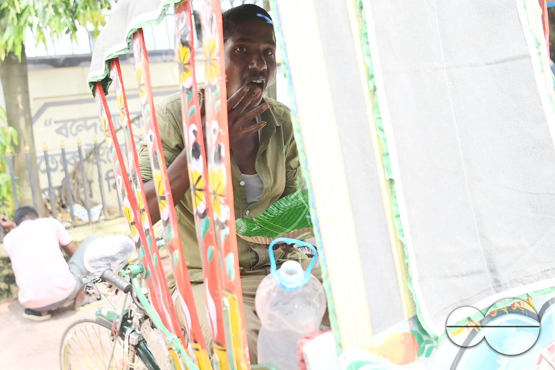 A rickshaw puller eats food distributed by a social worker on World Food Safety Day organised by Rotary Club of Agartala, in Agartala