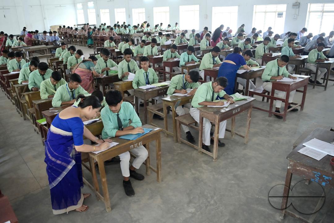 Students are seen writing an English paper