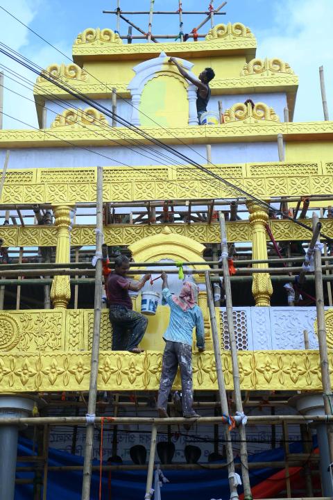Workers are making a pandal, a temporary structure set up to usually venerate the God and Goddess, ahead of Ganesh Chaturthi festival in Agartala