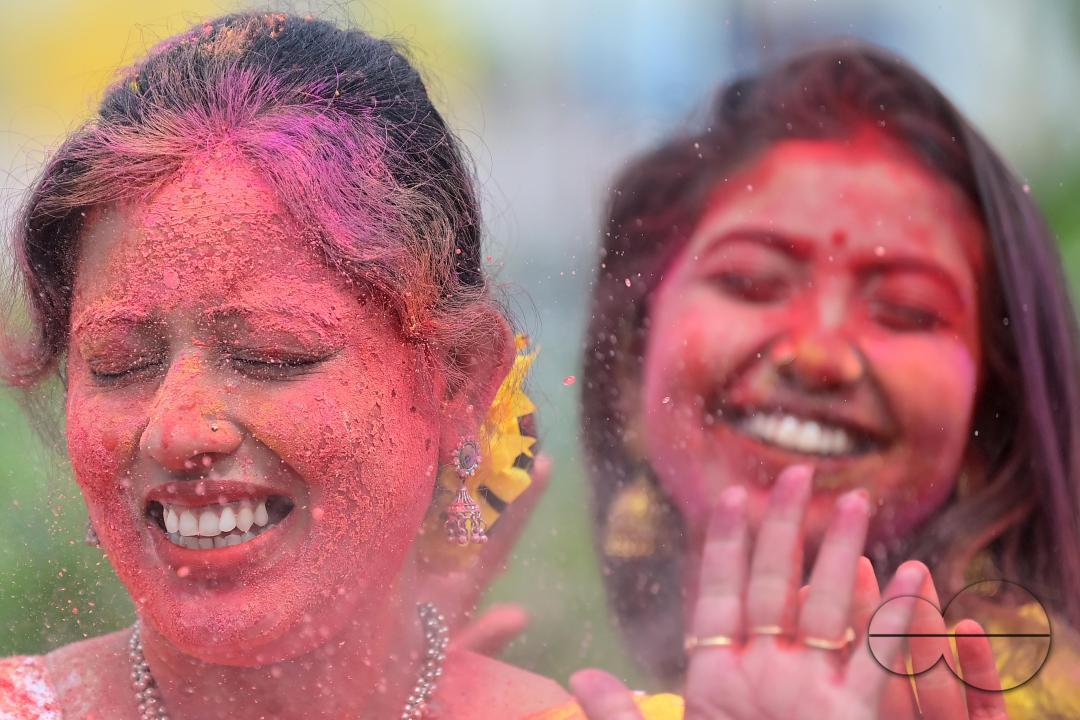 Indian girls adorned with 'Gulal' or coloured powder during the Hindu spring festival 'Holi', the festival of colour in Agartala