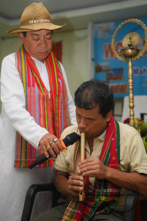 An indigenous blind musician playing the flute on the occasion of World Indigenous Day at an auditorium in Agartala