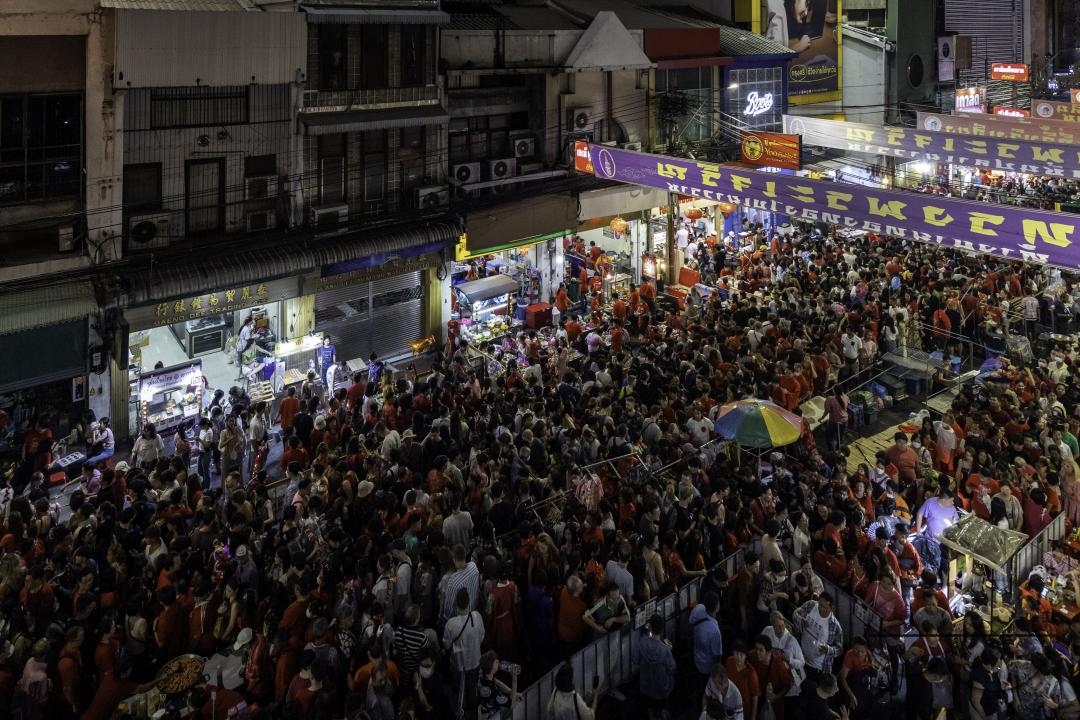 View of the crowded street of Yaowarat Road with people celebrating the Chinese New Year 2024 Festival in Chinatown, Bangkok, Thailand.