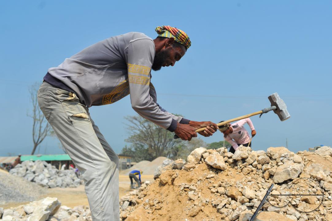 Male and female workers are breaking LC stones with a crusher machine in Bholaganj area, known as the 'Stone State' of Sylhet Companyganj Upazila