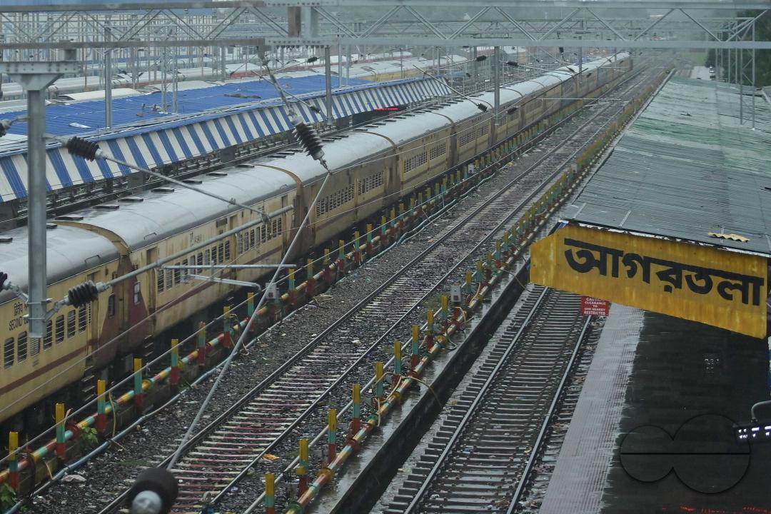 Train passengers are coming to Agartala railway station to catch the rescheduled interstate trains in heavy rain during Cyclone Remal in Agartala