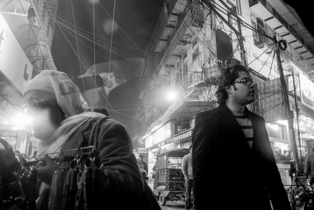 A busy street in a market area in Lahore at Midnight.