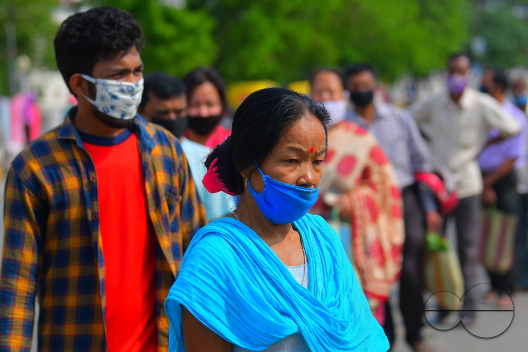 People are standing in a line, to check their temperatures