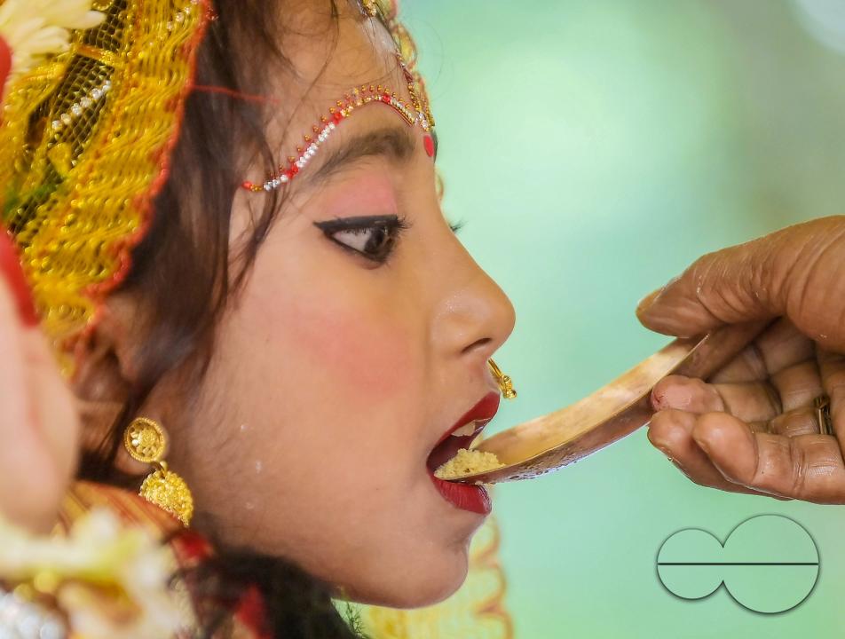 Priests worship a nine-year, five-month, and fourteen-day-old Hindu girl, Debalina Chakraborty, known as a "Kumari," who yawns during the Durga Puja religious festival at the Ramakrishna Vivekananda Ashram, operated by the Ramakrishna Mission on the outs
