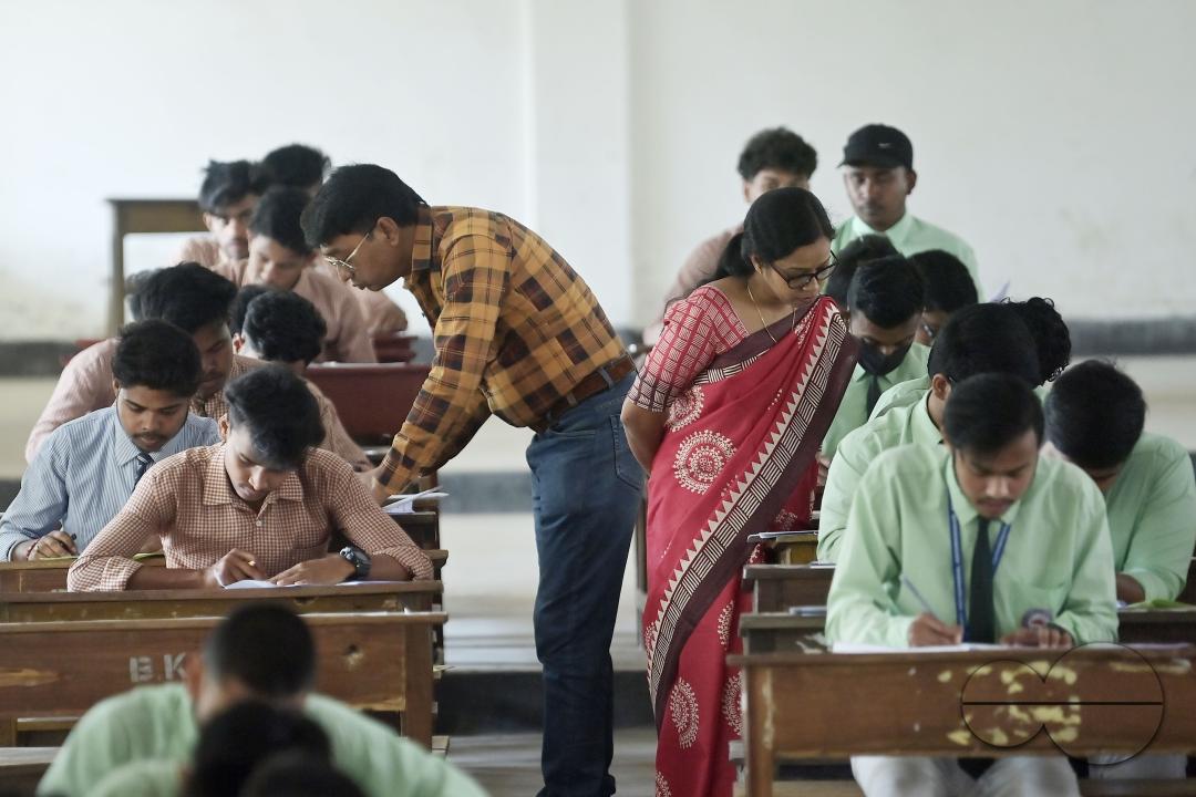 Students are seen writing an English paper