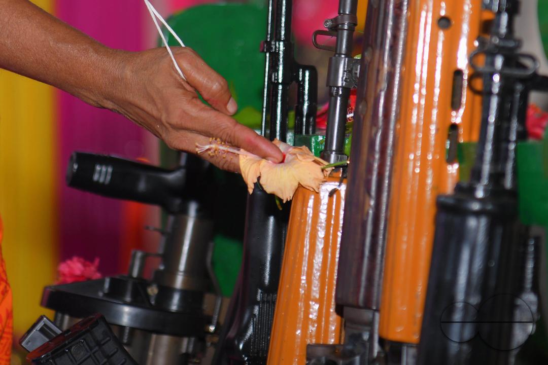 A priest performs worship of arms on Vishwakarma Puja in a TSR (Tripura State Rifles) camp on the outskirts of Agartala