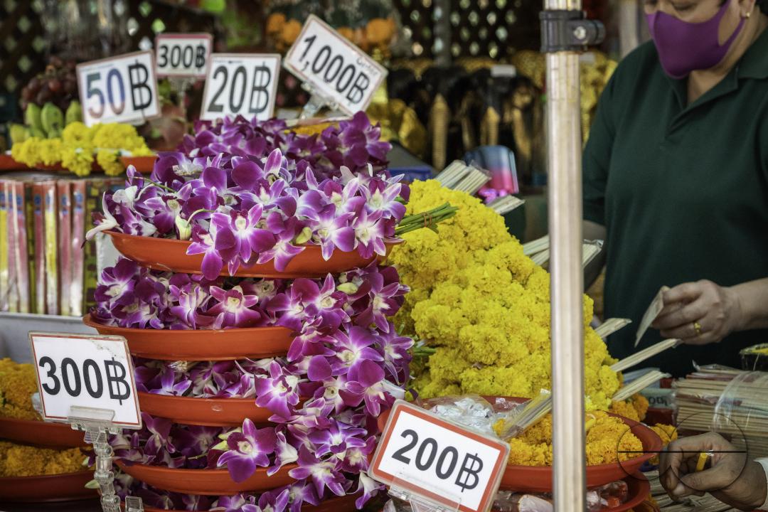 Display of flowers on sale for offerings and their respective prices, at the Erawan Shrine in downtown Bangkok