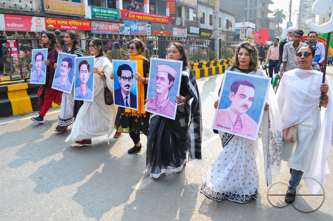 Culture activists at an alphabet march holding pictures of language martyrs to celebrate Language month with an alphabet procession in Sylhet