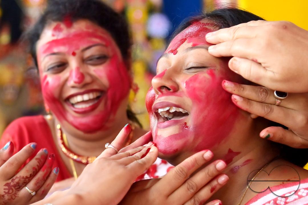 Married women smear each other with vermillion during a ritual called the vermillion game, or "Sindur Khela," on the last day of the Durga Puja festival in Agartala, Tripura, India.