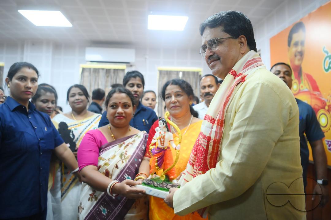 A lady tying rakhi and doing other rituals to Tripura CM Professor Dr