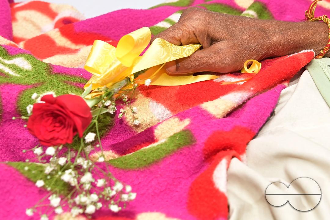 A rose and fruits are distributed to a patient by doctors and health workers during the celebration of World Kindness Day in the dialysis ward at IGM (Indira Gandhi Memorial) Hospital in Agartala