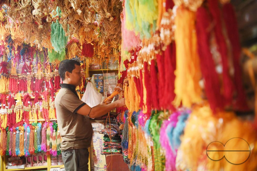 A shop owner arranging "Rakhi", sacred threads for the upcoming "Raksha Bandhan" festival at his shop in Agartala