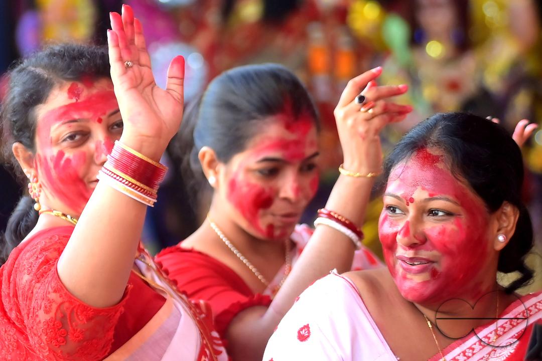 Married women smear each other with vermillion during a ritual called the vermillion game, or "Sindur Khela," on the last day of the Durga Puja festival in Agartala, Tripura, India.