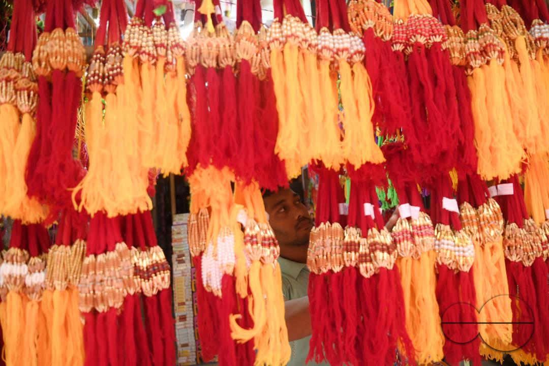 A shop owner arranging "Rakhi", sacred threads for the upcoming "Raksha Bandhan" festival at his shop in Agartala